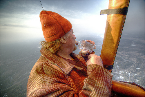 Man drinking in a hot air balloon over Helsinki, Finland