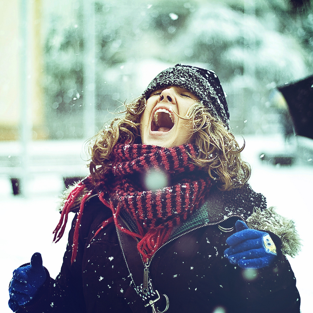 Woman catching snowflakes in her mouth in Catalonia, Spain