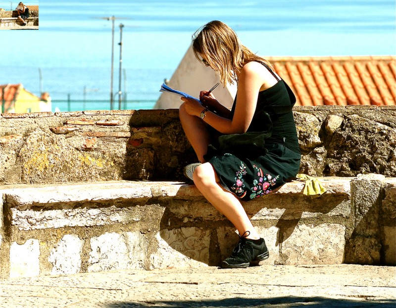 Girl writing in notebook, Lisbon, Portugal