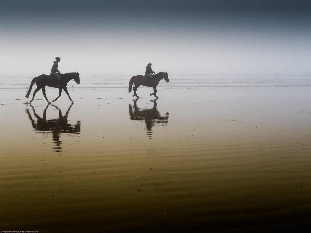 2 Girls Riding Horseback at Morro Strand State Beach, California