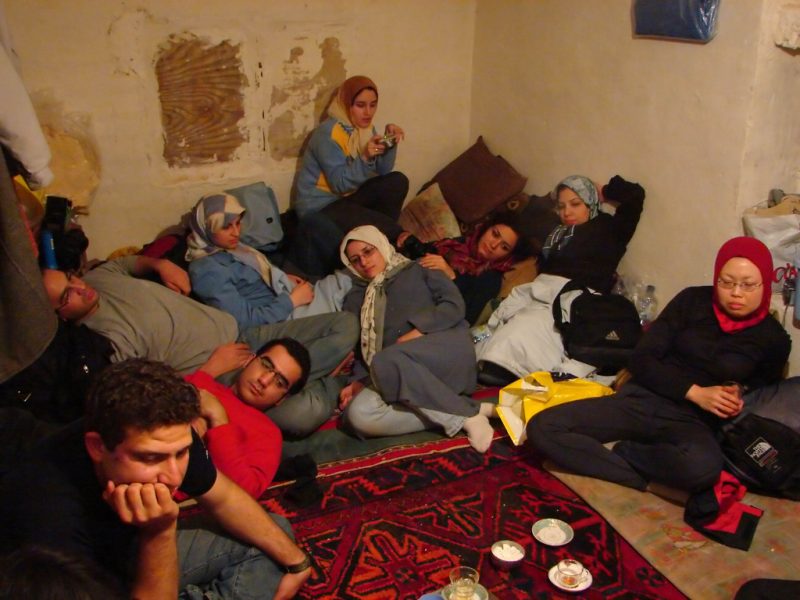 Group of houseguests/travelers relaxing on a floor