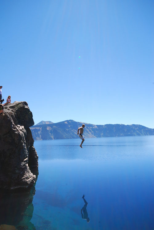 Man Jumping Into Crater Lake in Oregon