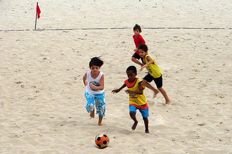 Kids playing football on the beach in Ipanema, Rio de Janeiro, Brazil