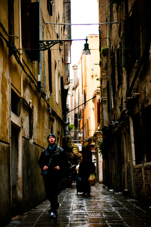 Solo traveler walking streets of Venice, Italy