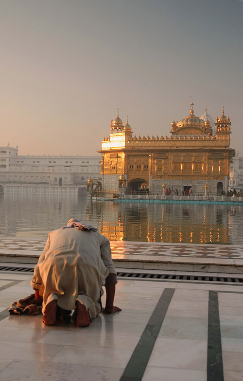 Man paying obeisance towards Golden Temple in Punjab, India