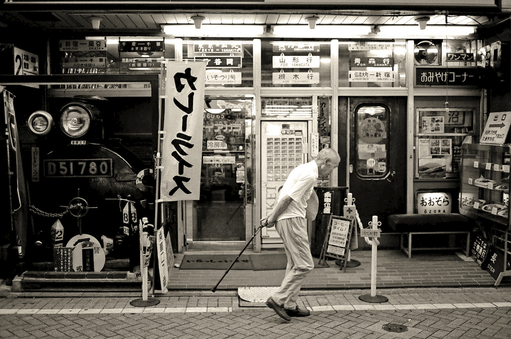 Old man walking street in Tokyo, Japan (black and white)