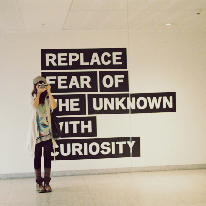 Sign: "Replace fear of the unknown with curiosity."