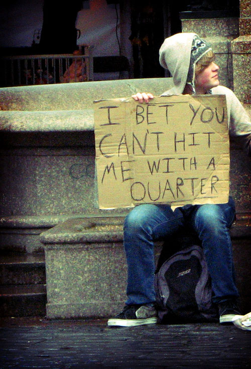 Boy with Sign: I Bet You Can\'t Hit Me with a Quarter