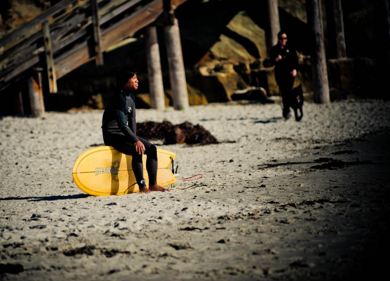 Surfer Waits for Better Waves, California