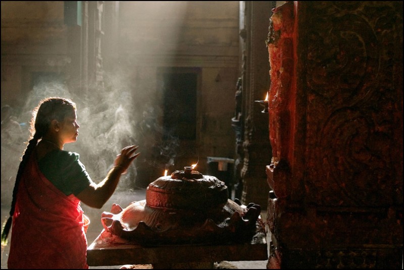 A woman praying Hanuman, the monkey god in the superb Meenaskshi temple, Madurai, India