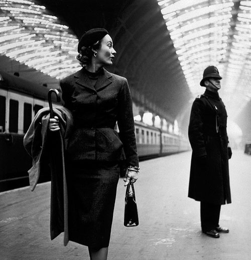 Woman walking through Victoria Station, London (1951)