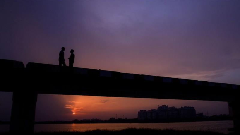Friends on a Bridge at Twilight, Chennai, India Friends on a Bridge at Twilight, Chennai, India